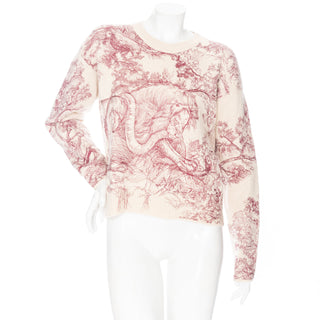 Christian Dior red and cream embroidered Toile De Jouy cashmere sweater featuring a lion, snake, and monkey in SIze FR 38, an estimated US Size 6 or Small, available at designer and vintage specialty consignment shop "Decades" in Los Angles.