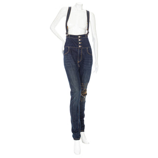 Preowned Vivienne Westwood Angolomania Blue Denim and Yellow Print High-Waisted Skinny Overalls in Size 26. Available and vintage and designer specialty consignment shop Decades in Los Angeles.